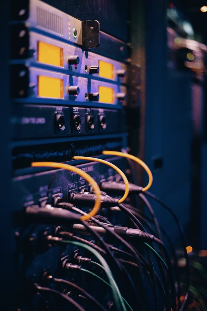 pexels photo 1054397 Close-up of network cables and ports in a server rack, showcasing connectivity.